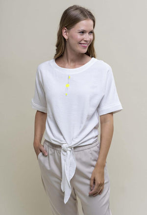 <p>Hongo knot tie front top in white with small yellow print at front of round neckline </p>