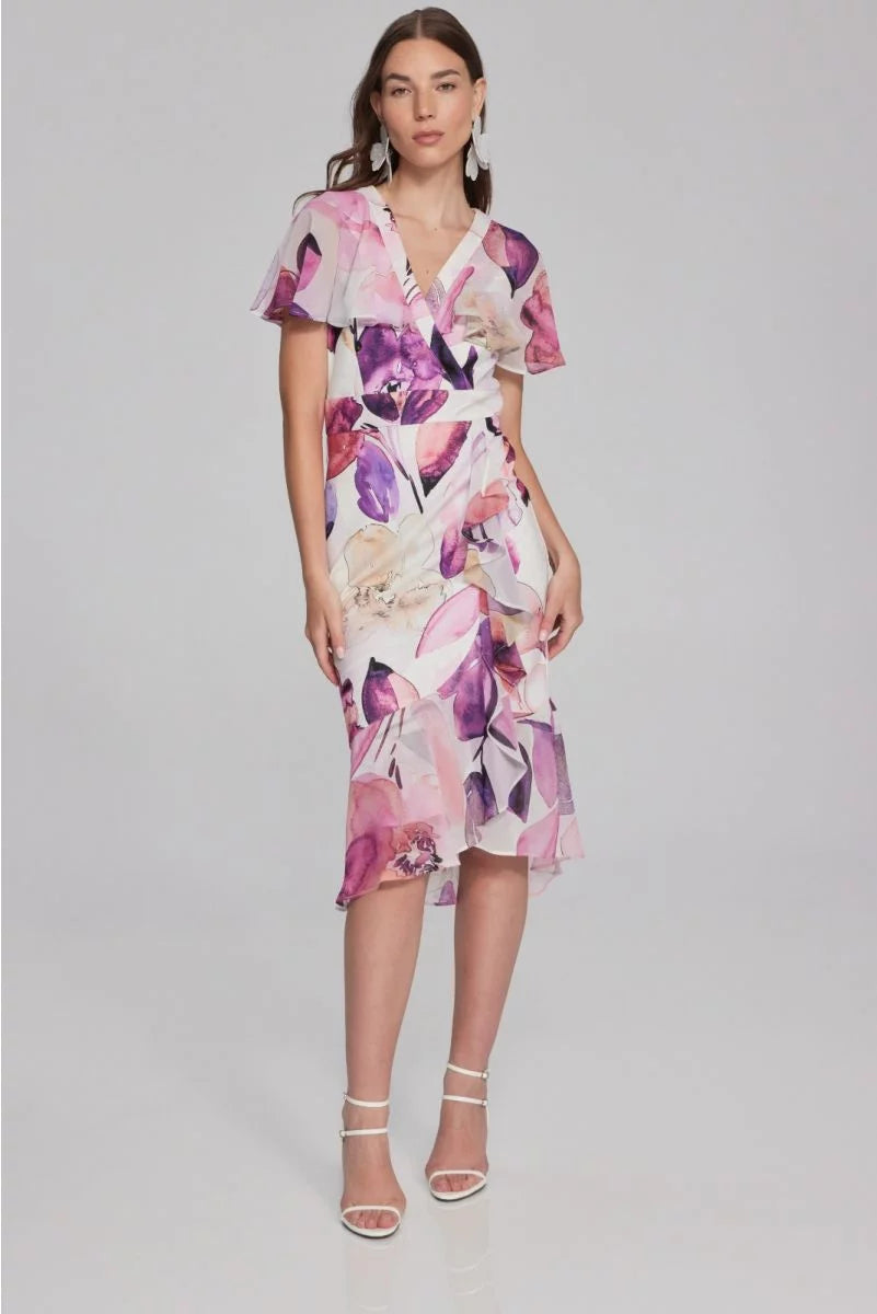 <p>Joseph Ribkoff floral print wrap style dress with chiffon sleeves and trims in white with pink and purple shades in print </p>