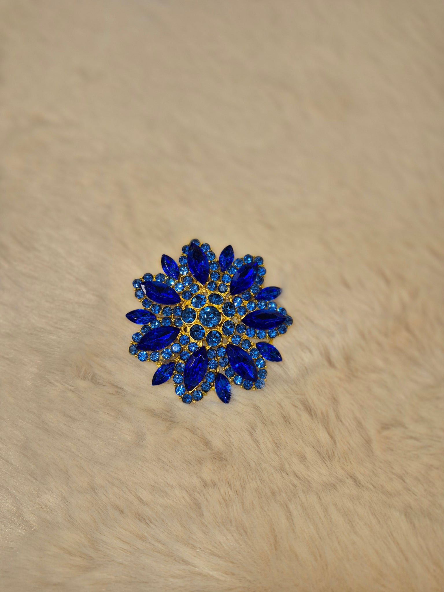 Diamante flower brooch in blue